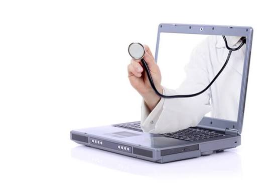 Doctor's hand with stethoscope beside a laptop, representing online medical consultations